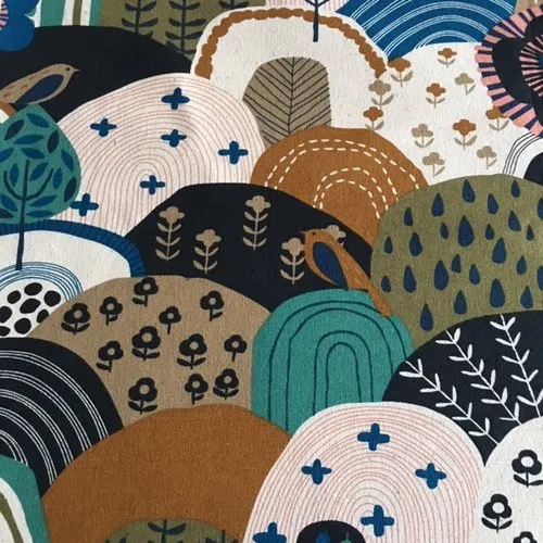 Cotton canvas fabric with nature design of birds and trees in blue, white, and ochre colors. Ideal for making bags and cushions.